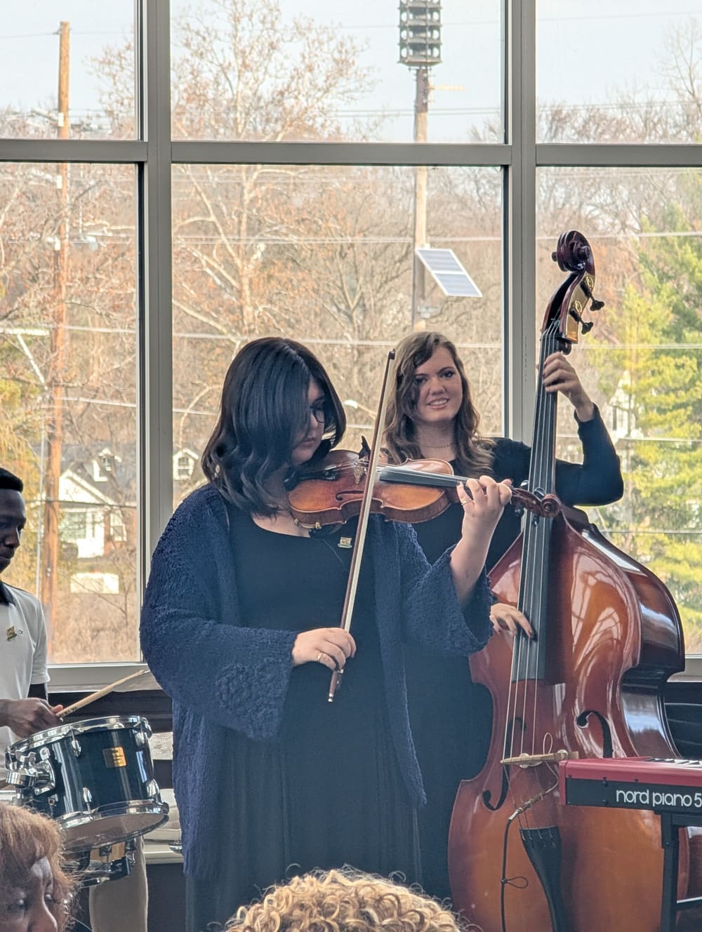 Mara on bass beside the violinist